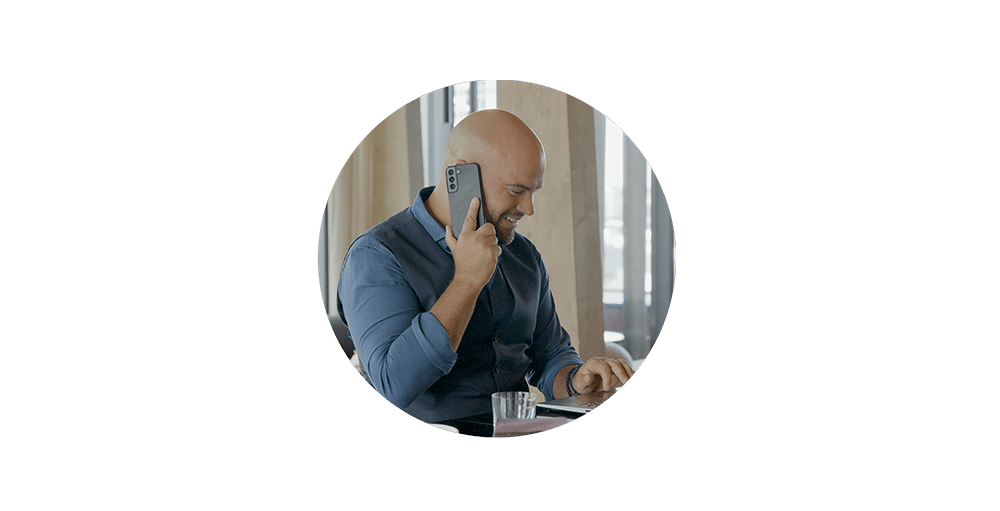 Man on a phone using a trivec POS system